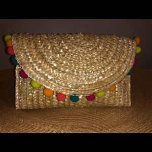 Clutch straw bag with colorful Pom poms.